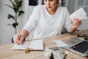 Woman organizing her finances at a desk after a divorce