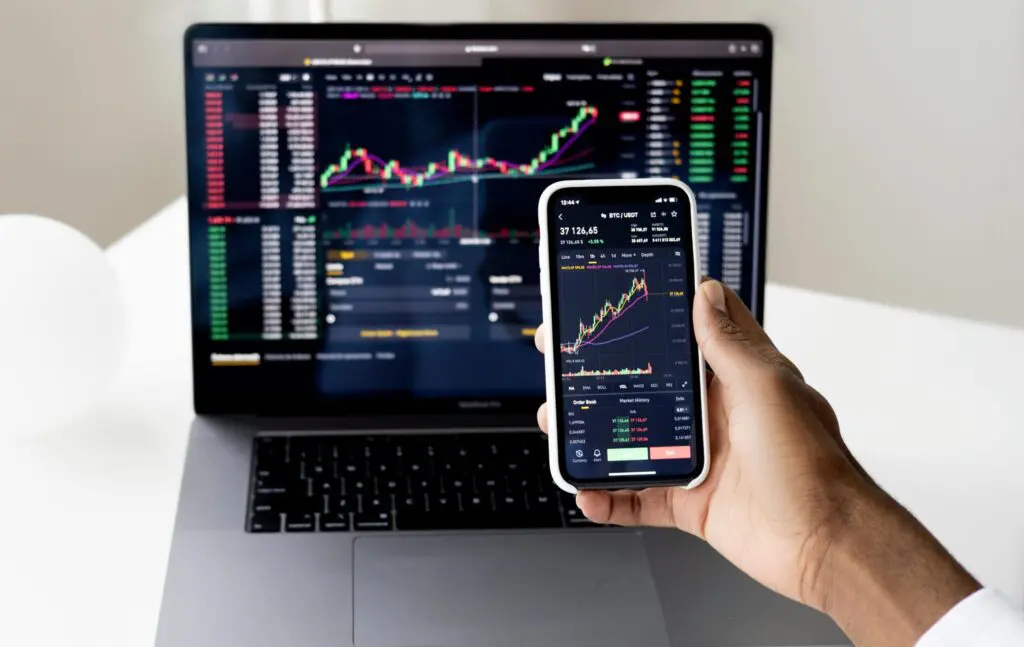 stock market chart on the laptop and phone