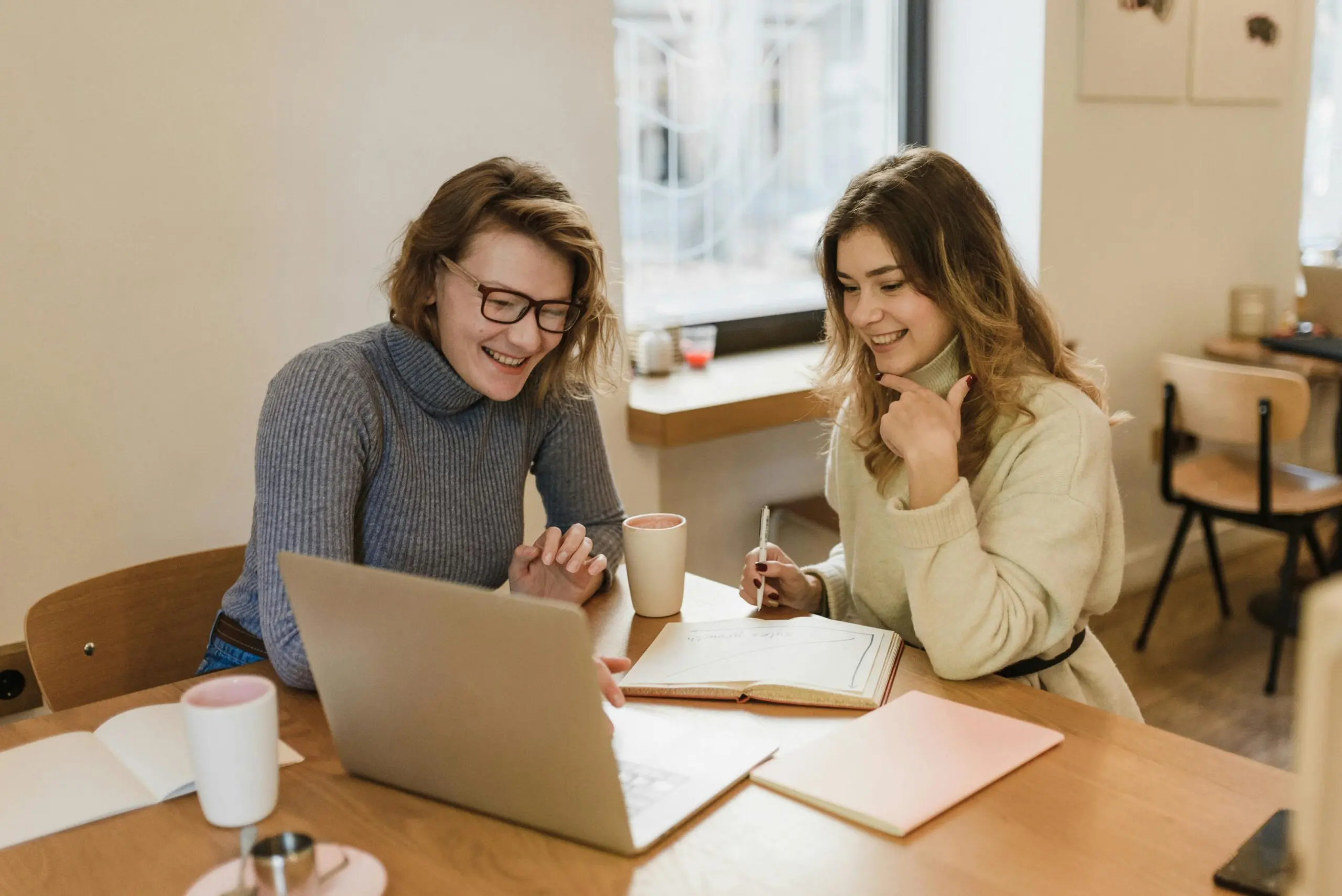 professional women looking into the laptop screen and smiling