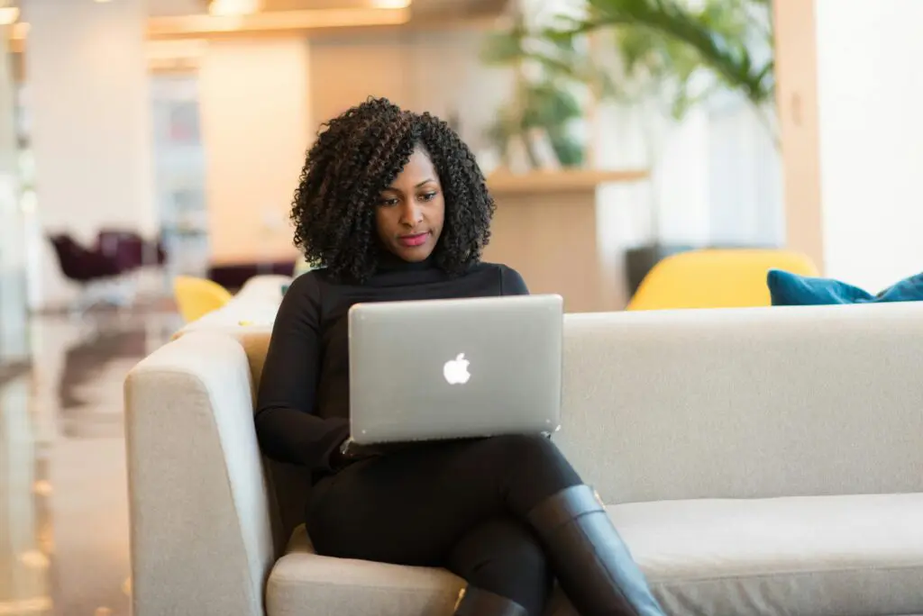 Professional woman in her 50s reviewing her financial accounts on a laptop
