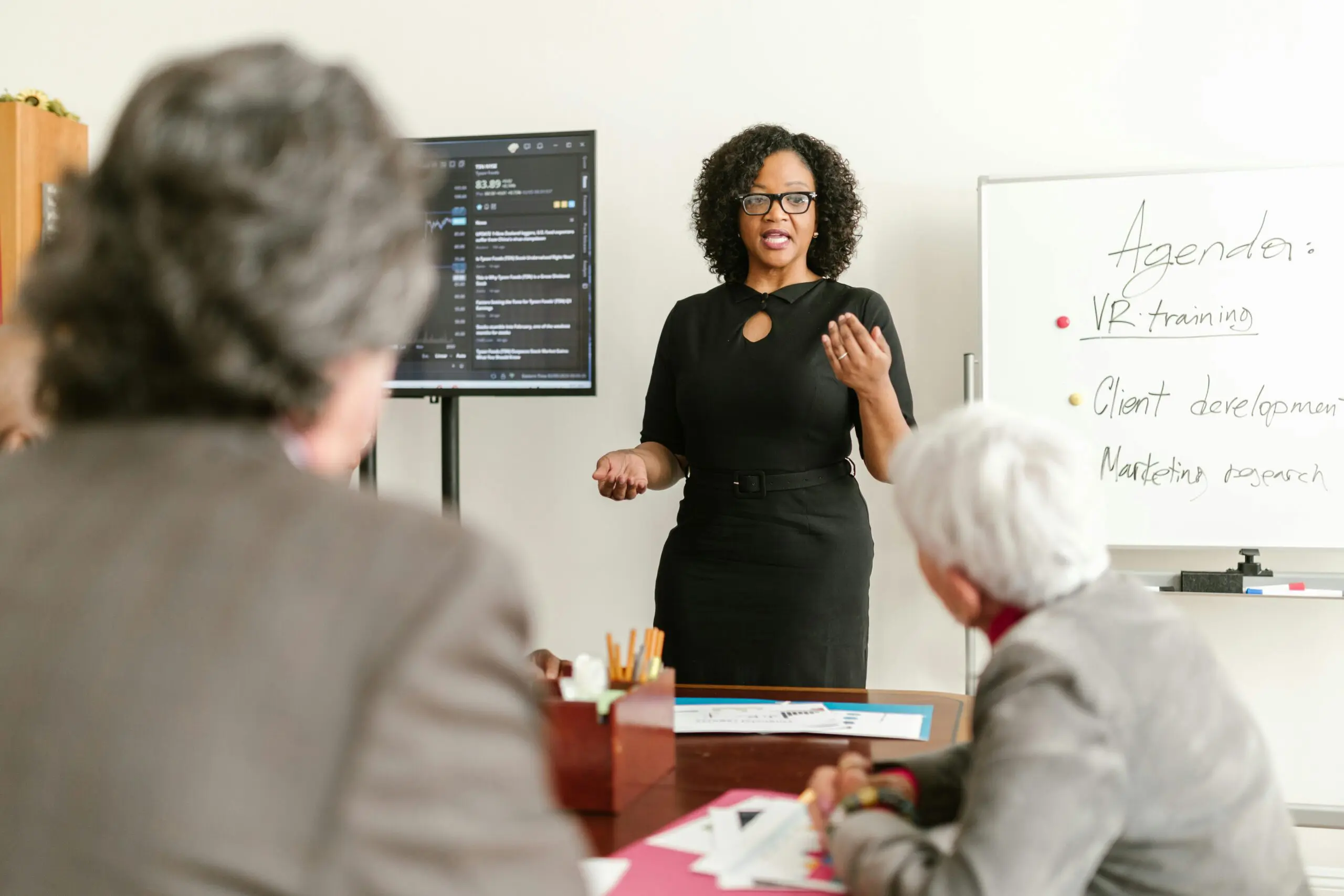 Woman leading a financial planning discussion with colleagues in a conference room