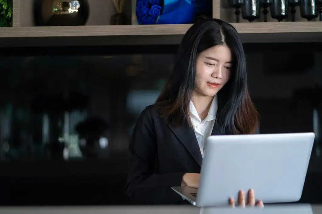 Professional woman working on her laptop in the evening