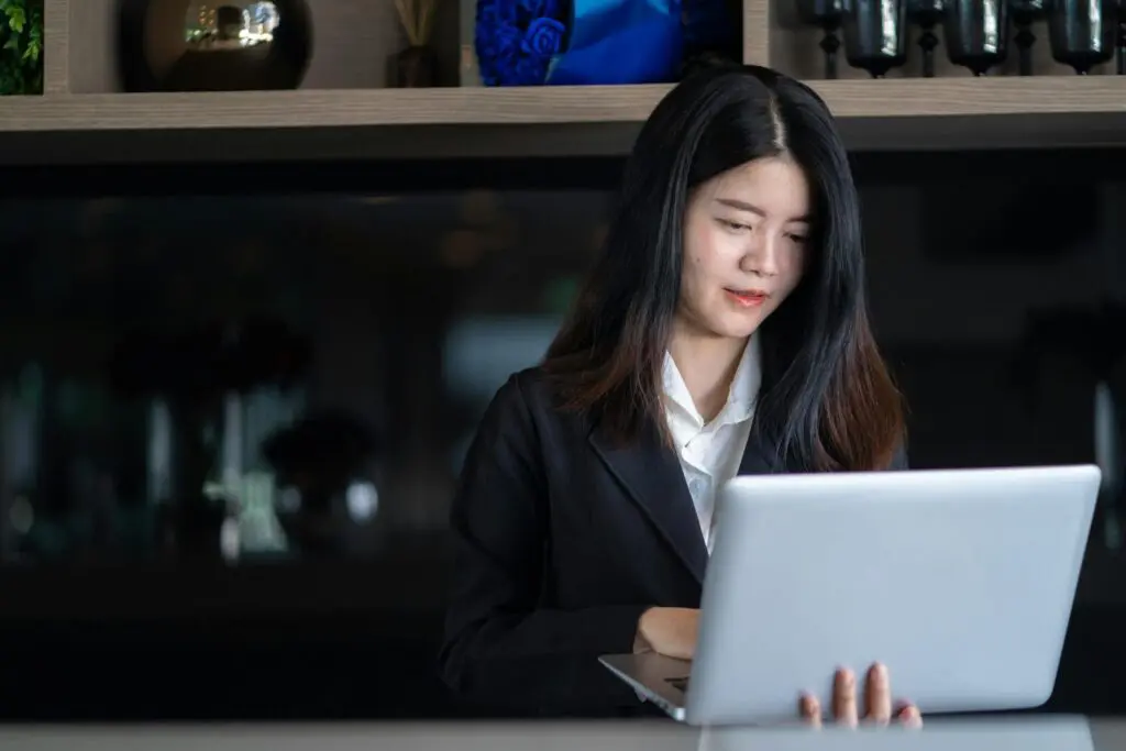 Divorced woman reviewing her Social Security benefit options at her laptop
