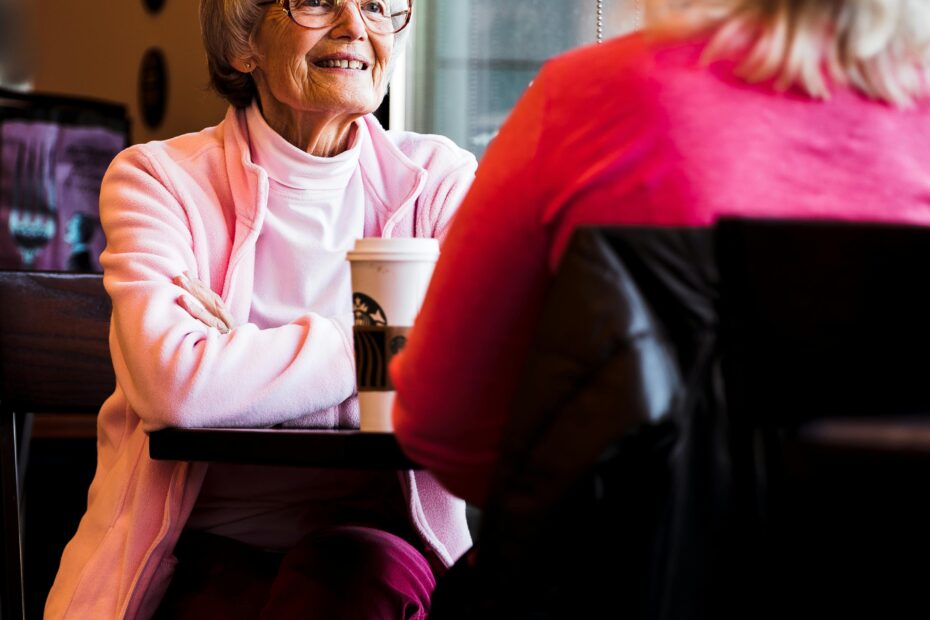 woman in pink talking to her friend