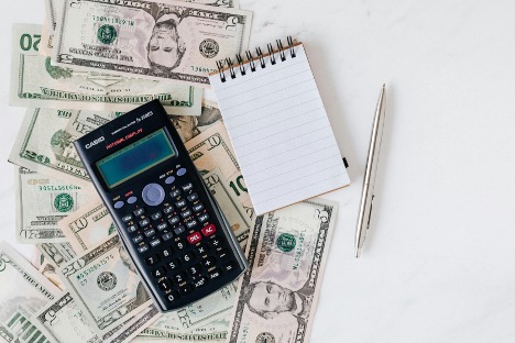 money and notebook with a calculator