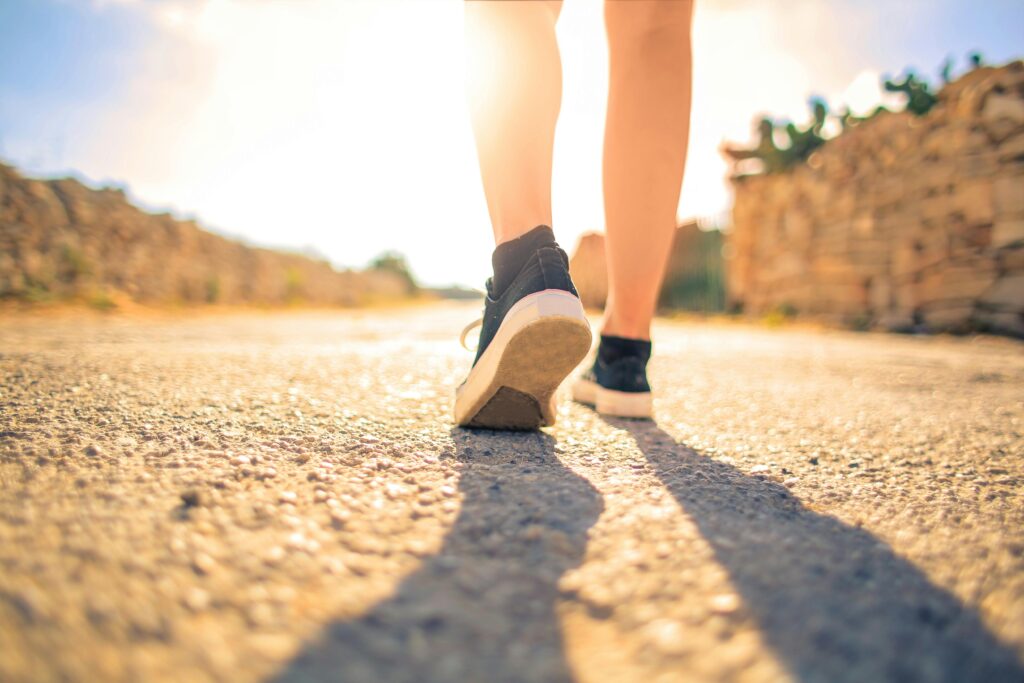 woman in running shoes under the sun