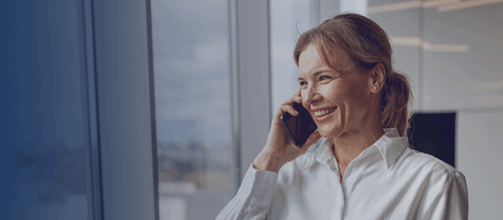woman is answering the phone by the window