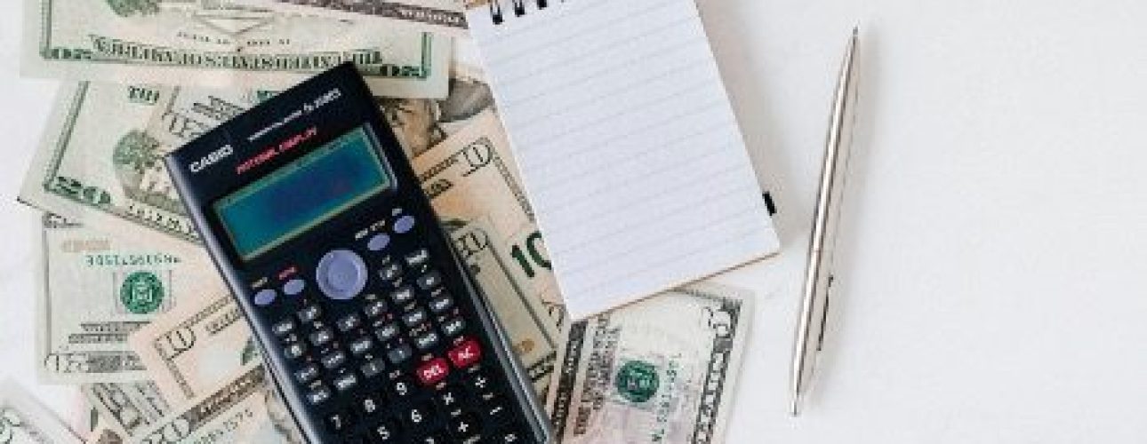 money and notebook with a calculator