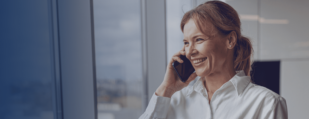 woman is answering the phone by the window