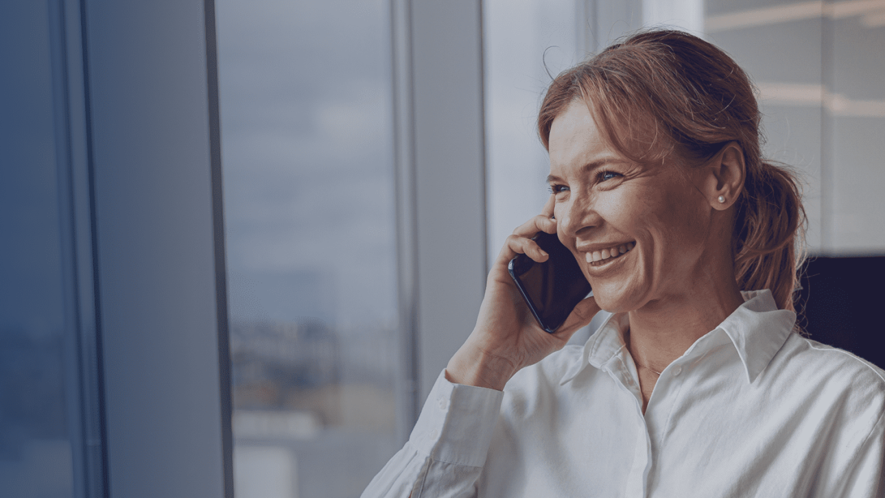 woman is answering the phone by the window