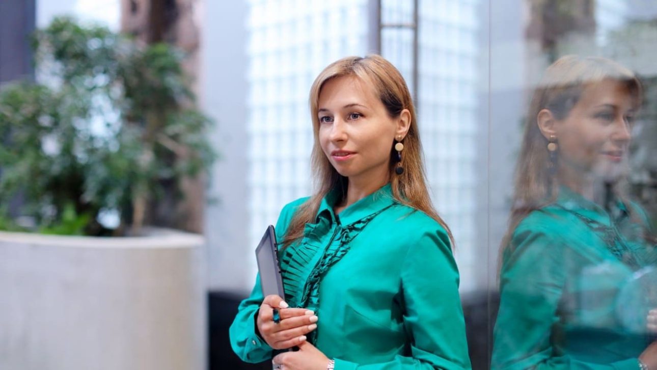 Executive woman reviewing her Amazon employee benefits options at a corporate office