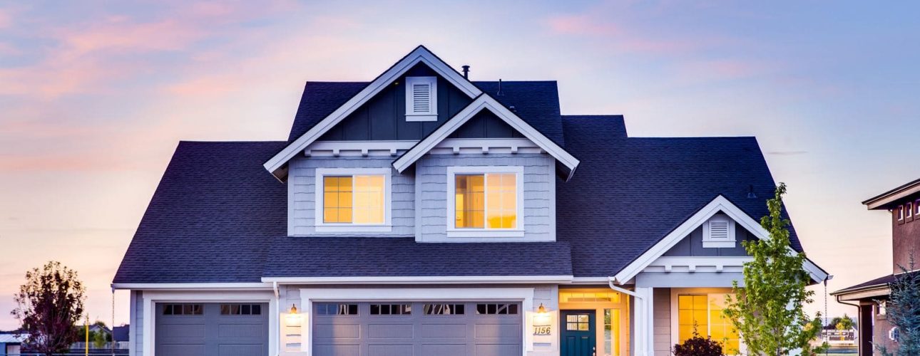 A well kept two story family home at dusk, the kind of house a widow must decide whether to sell or keep