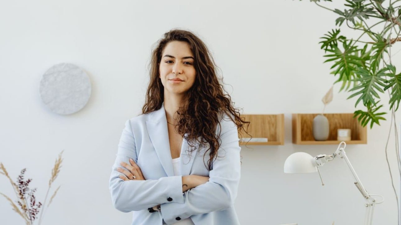 Confident executive woman considering her Microsoft employee benefits in a modern office