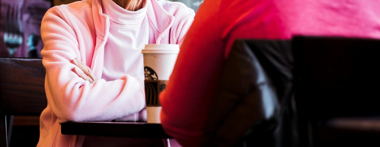 widowed woman in pink talking to her friend
