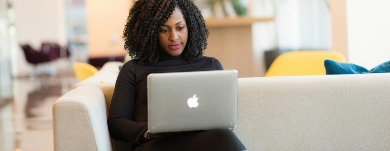 professional woman working on her laptop sitting on a couch
