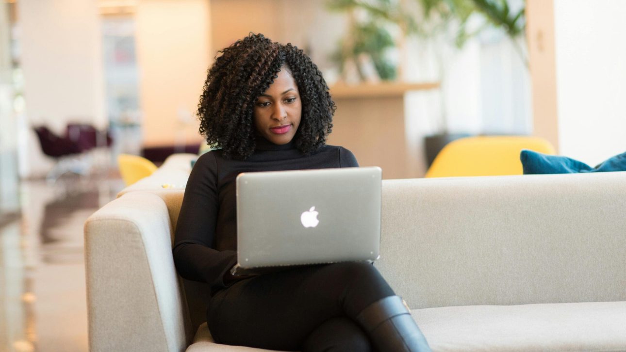 Professional woman in her 50s reviewing her financial accounts on a laptop