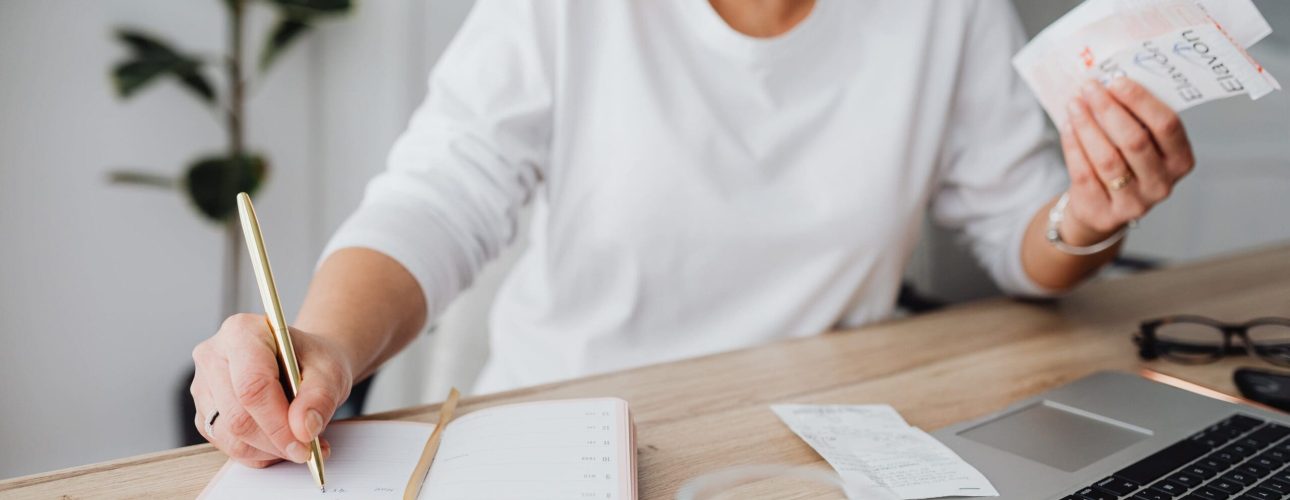 Woman organizing her finances at a desk after a divorce
