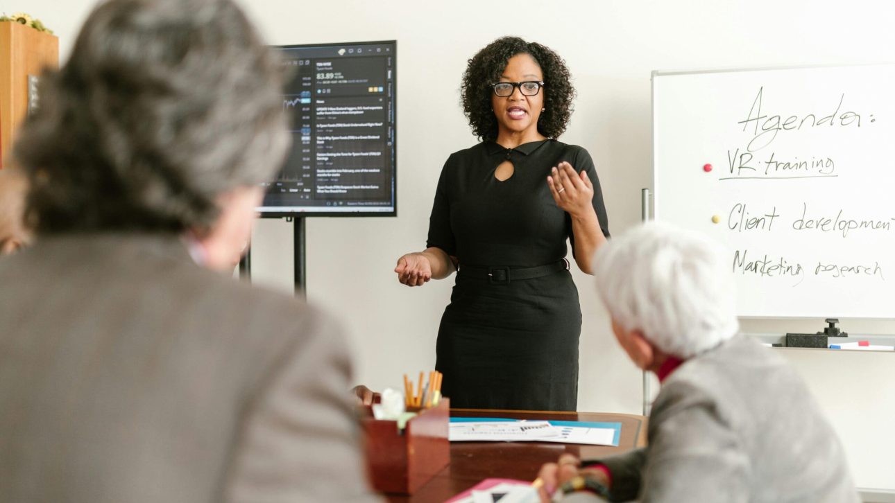 Woman presenting a financial workshop to a small group