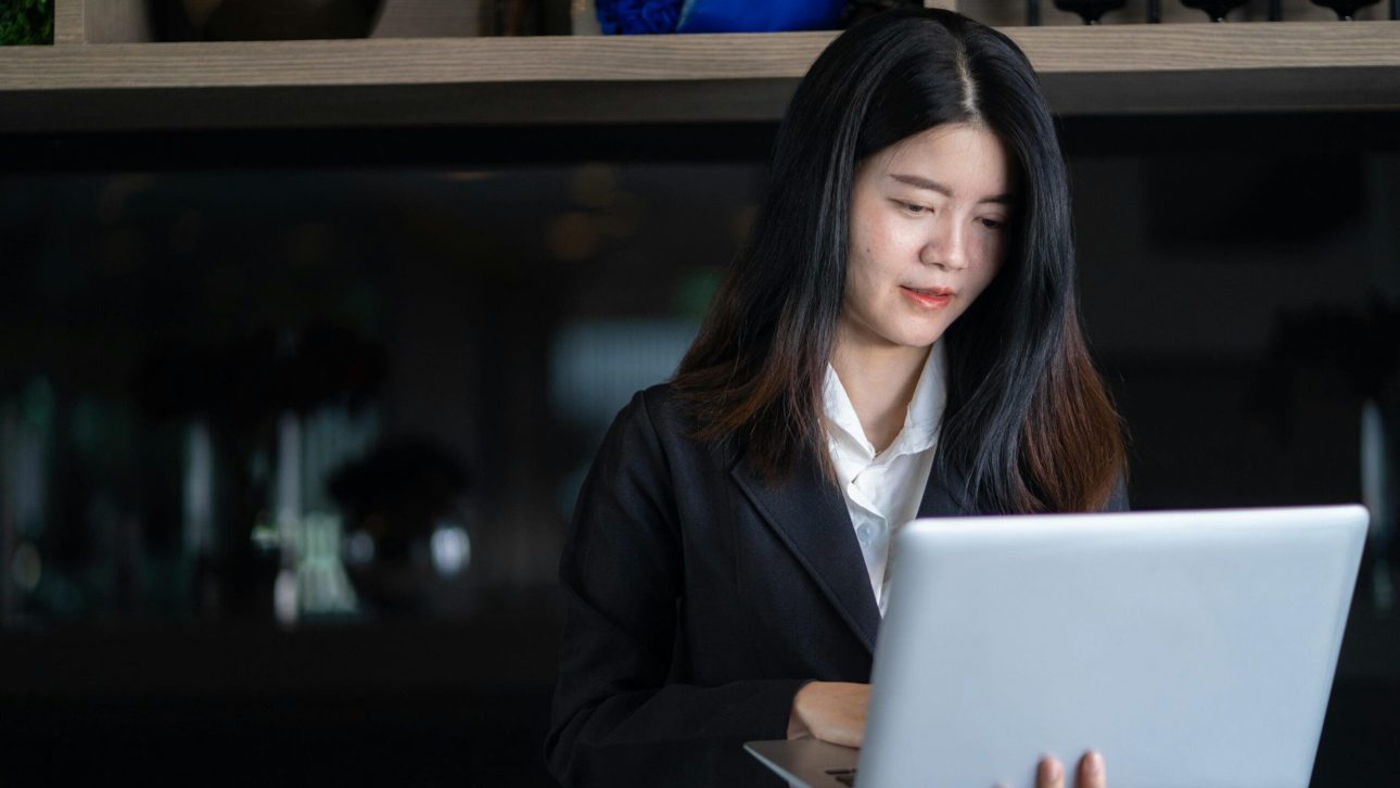 Professional woman working on her laptop in the evening