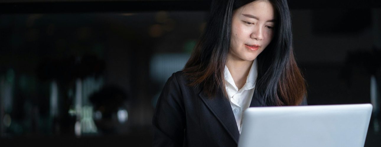 Divorced woman reviewing her Social Security benefit options at her laptop